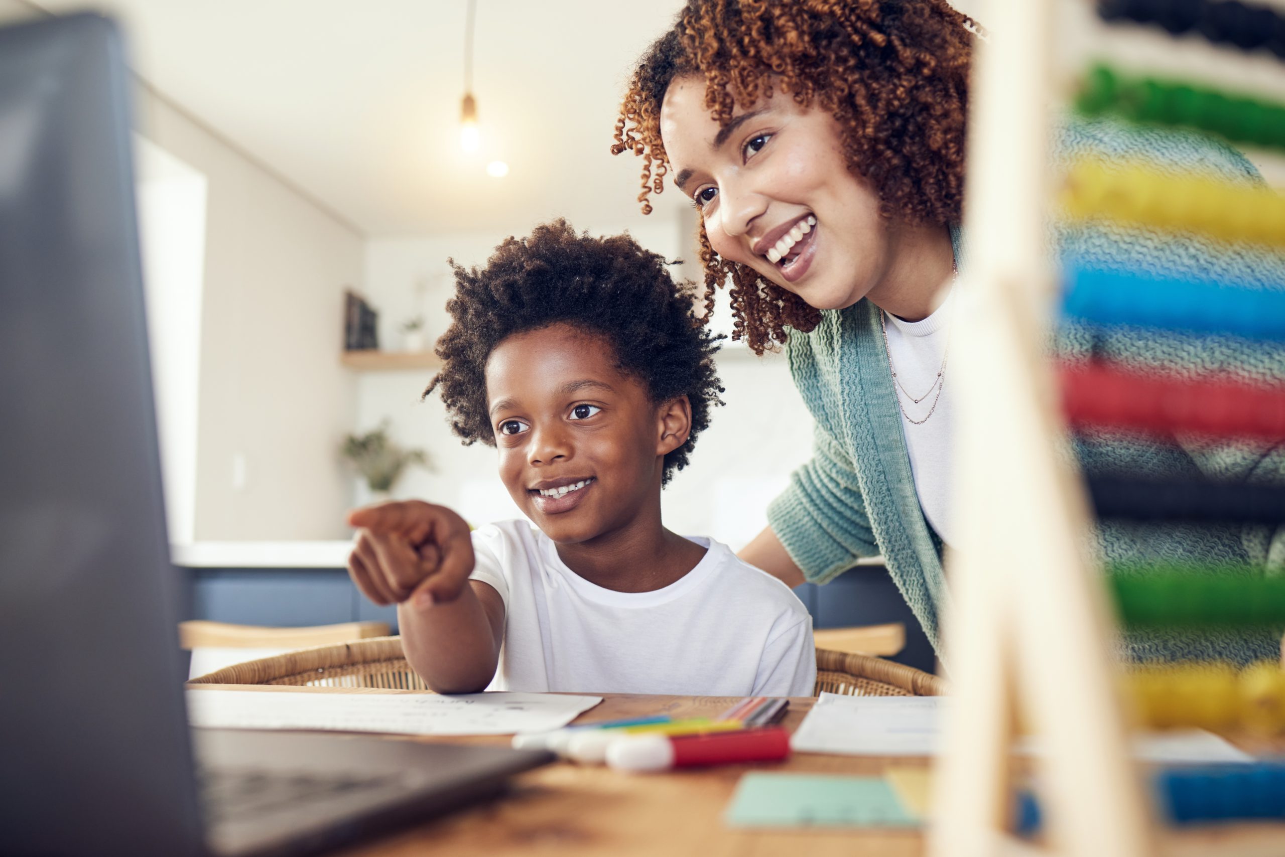 African mother and child using a laptop for online learning and education